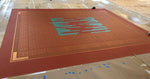 Load image into Gallery viewer, A production photo showing the marked off abstract center of the design for Autumn Leaves Floorcloth #8.