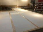 Load image into Gallery viewer, Production image of gessoed canvas required for the Chambers House floorcloth which is wider than 10' so required two layers of canvas.