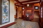 Load image into Gallery viewer, In-situ image of a shaped floorcloth, made to perfectly fit this space. The design is an all over floral pattern by Christopher Dresser. The Peacock is an original wallpaper panel c.1910 from Arthur Sanderson & Sons. Photo by Sally Painter.