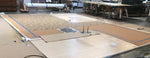 Load image into Gallery viewer, Production image of this shaped floorcloth being stenciled.