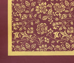 Load image into Gallery viewer, The corner of this floorcloth with a one inch ochre band and a two inch band of the burgundy background color.
