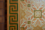 Load image into Gallery viewer, Close up of this floorcloth’s deco center motifs, based on a design by Christopher Dresser.  The border employs a Greek Key design. Photo by Sally Painter.