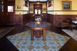 Load image into Gallery viewer, In-Situ image of this floocloth based on a Christopher Dresser pattern with Greek Key and Fleur de lis elements. Photo by Sally Painter.