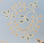 Load image into Gallery viewer, A close up of one of the circular leaf and berry motifs that adorn the center of this floorcloth.