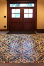 Load image into Gallery viewer, In-situ image of this floorcloth based on a Christopher Dresser design with  and overall diamond effect and deco elements.
