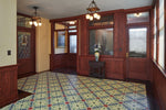 Load image into Gallery viewer, In-situ image of this floorcloth based on a Christopher Dresser design with an overall diamond effect and deco elements. Photo by Sally Painter.