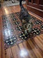 Load image into Gallery viewer, Jade on her new floorcloth.