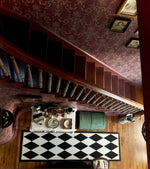 Load image into Gallery viewer, A view of this Harlequin Floorcloth from the second floor .