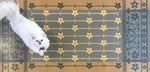 Load image into Gallery viewer, A full image of our StarFlower Floorcloth #4 with Opal providing scale.
