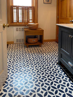 Load image into Gallery viewer, Shaped floorcloth with interlocking circle pattern installed in bathroom.