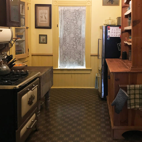 A renovated 1890 kitchen with a floorcloth replicating and replacing the original wall-to-wall linoleum floor.