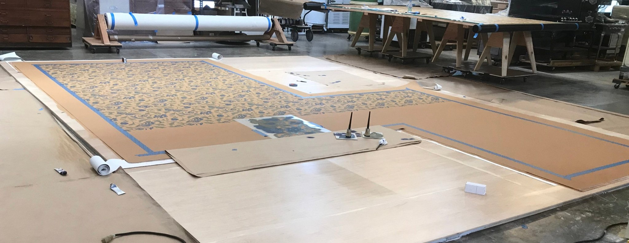 Production image of this shaped floorcloth being stenciled. 