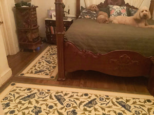 This is an image of this floorcloth installed in a bedroom, next to another one of three floorcloths in this room, with the same pattern, but different shapes, to offer maximum floor coverage. 