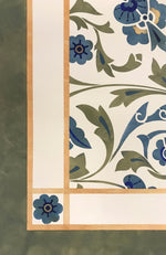 Load image into Gallery viewer, A close-up image of the corner of this floorcloth with an all-ver floral pattern.
