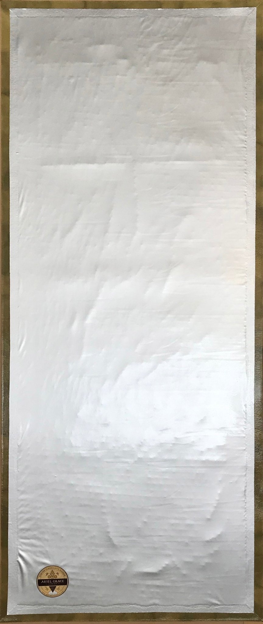 The backside of this floorcloth, showing the waterproof vinyl layer which is adhered to the hem.  There is a layer of carpet padding sealed between the vinyl and the canvas.