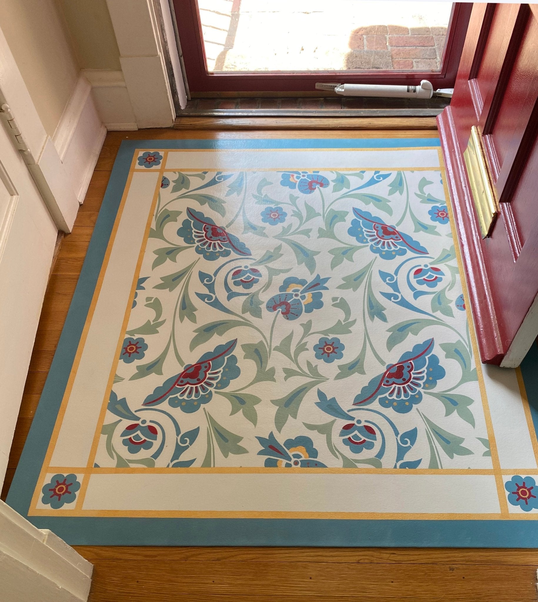 An in-situ image of All-Over-Floral Floorcloth #6 in its entryway.