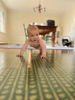 Load image into Gallery viewer, Autumn Leaves Floorcloth #5 being crawled on by the world&#39;s cutest baby.
