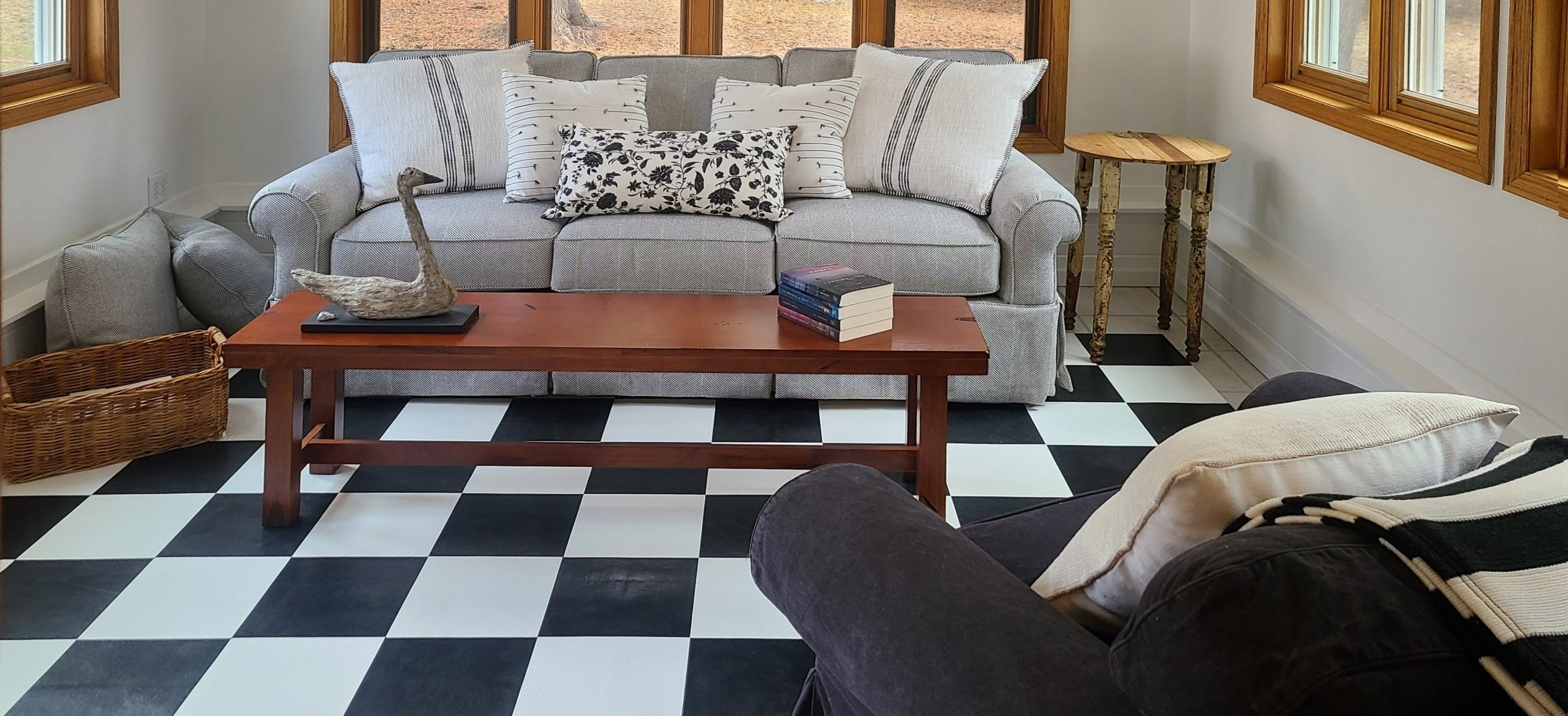 In-situ photo of Checkerboard Floorcloth #1 in the fully appointed guest room. 