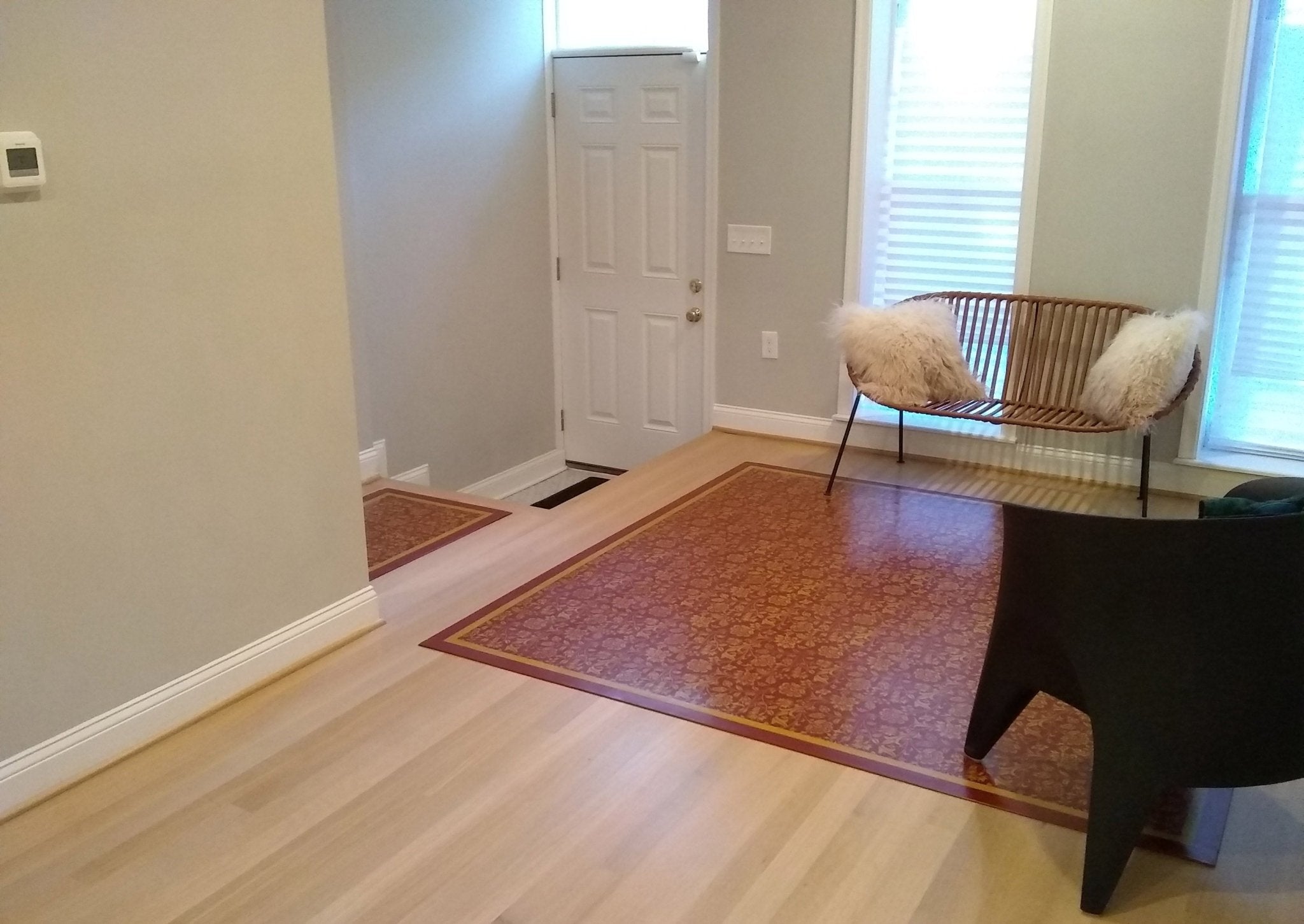 In-situ image of this floorcloth in it's new home and looks great with the modern decor.