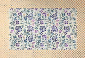 Full view of this small floorcloth with a colorful chintz center and a small checkerboard border.