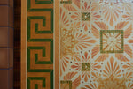 Load image into Gallery viewer, Close up of this floorcloth’s deco center motifs, based on a design by Christopher Dresser.  The border employs a Greek Key design. Photo by Sally Painter.
