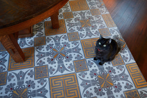 In-Situ image of this floocloth based on a Christopher Dresser pattern with Greek Key and Fleur de lis elements. Scale provided by Tanuki. Photo by Sally Painter.