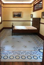 Load image into Gallery viewer, In-situ image of this floorcloth, the design of which is based on a ceiling pattern in the 1889 Robert Graves Co. Wallpaper Catalog.

