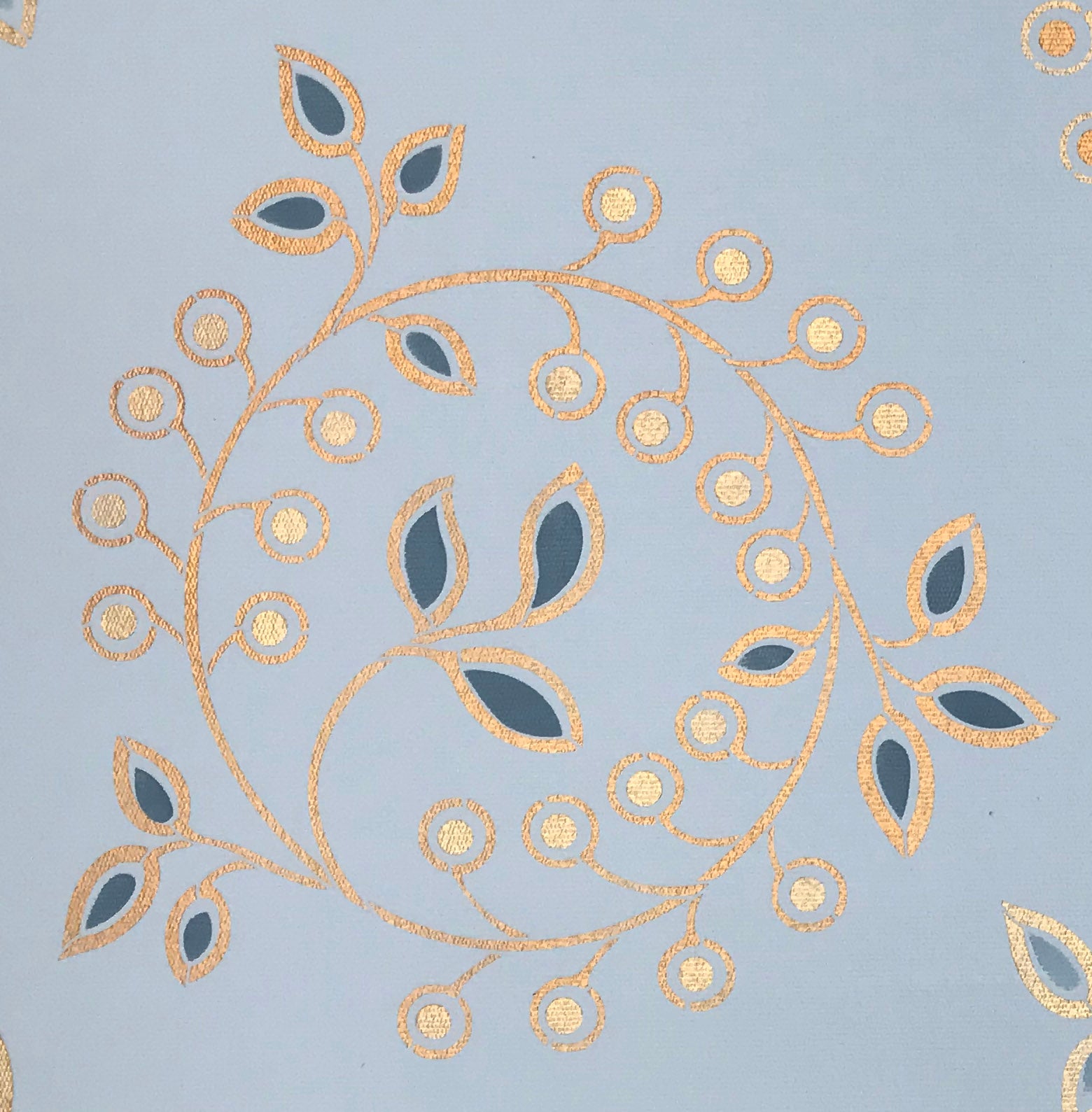 A close up of the other circular leaf and berry motifs that adorn the center of this floorcloth.