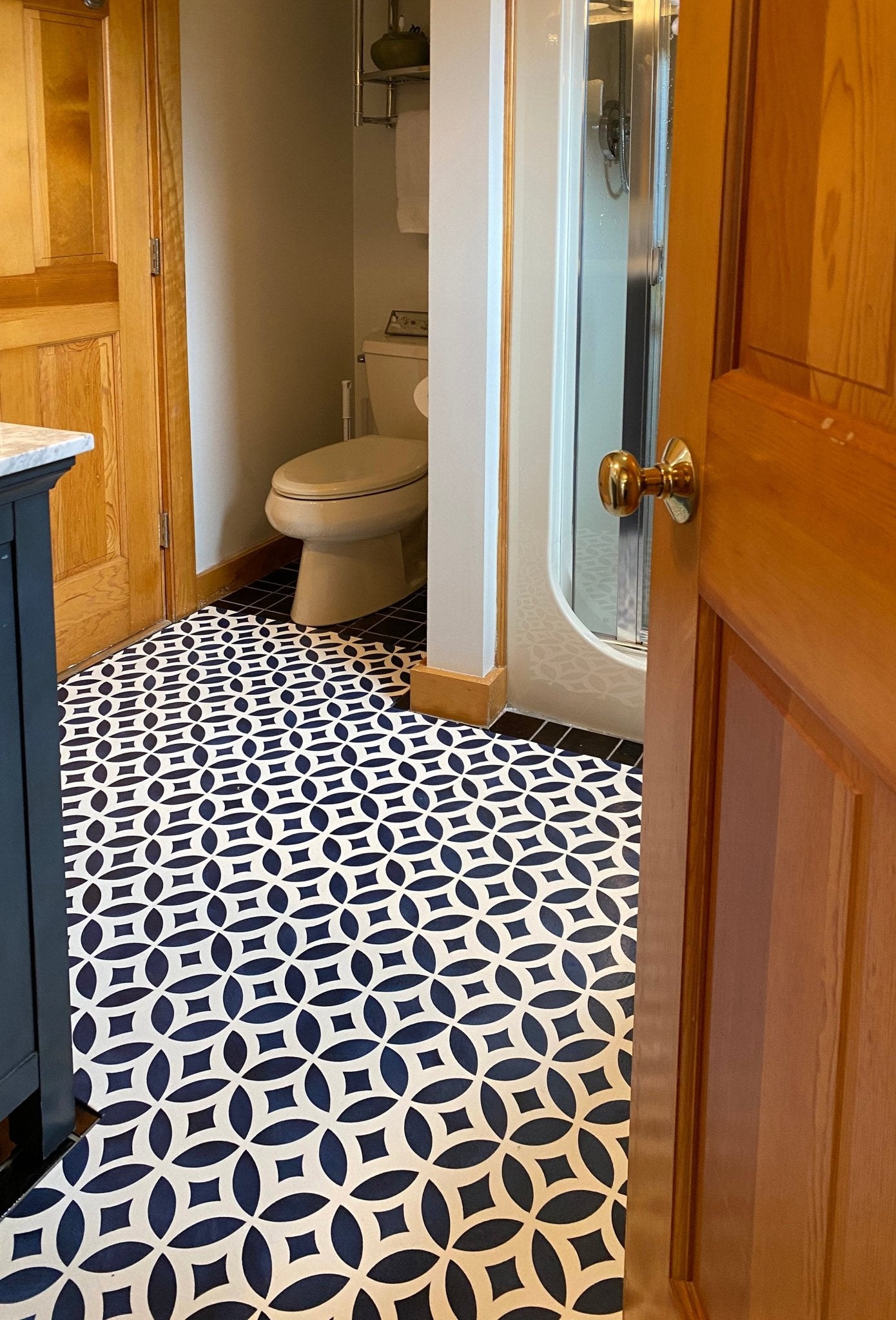Shaped floorcloth with interlocking circle pattern installed in bathroom-differrent angle.