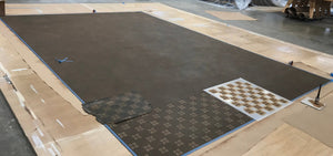 This shows the stippled background of the floorcloth, with the first layer of stenciling being applied in a cream color.