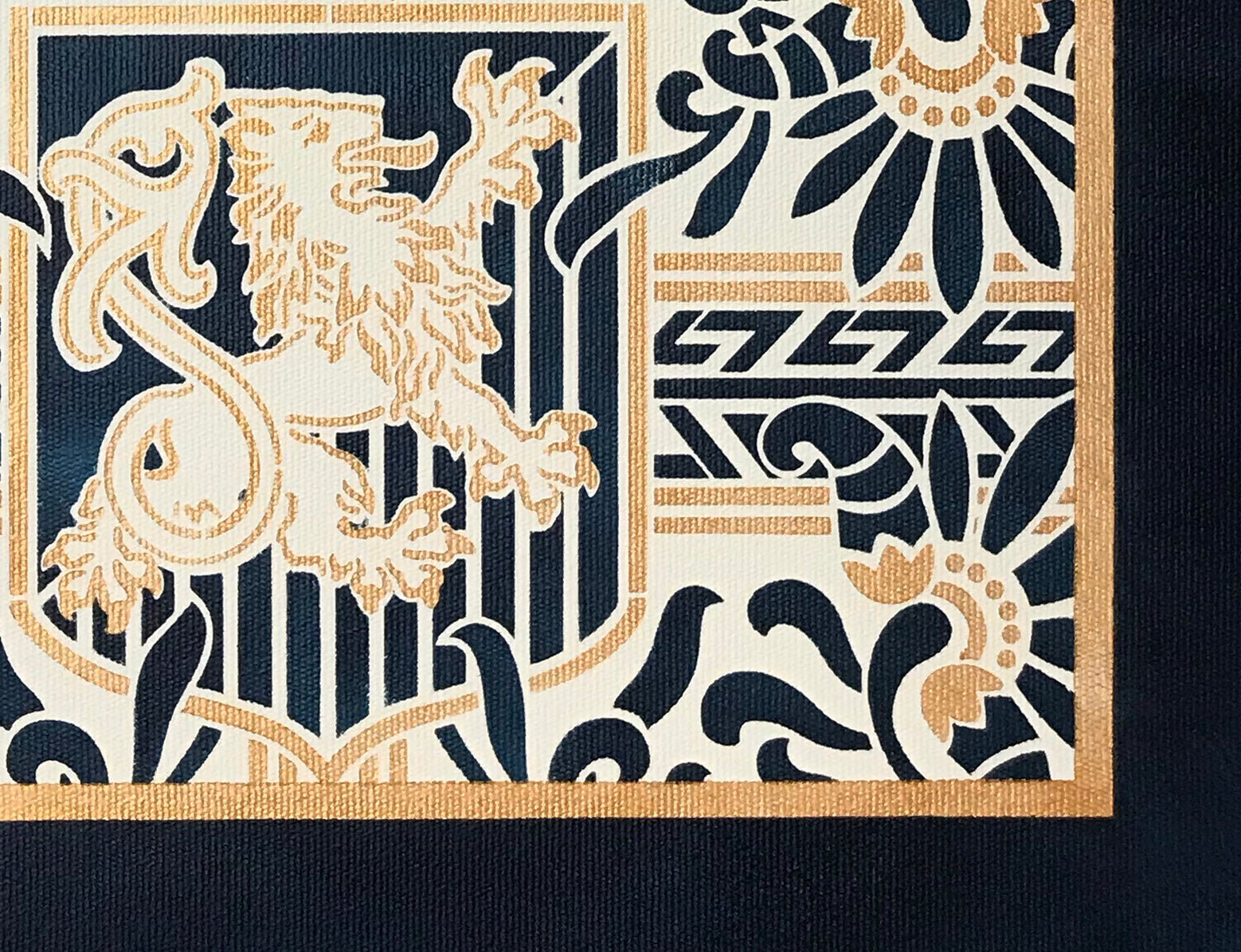 A corner view of the pattern for this floorcloth featuring a lion in shield with floral and Greek Key elements.