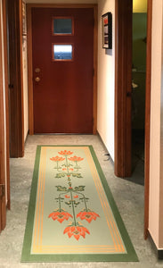 An in situ photo of Poppy Floorcloth #2 at the entrance to this mid century modern house.