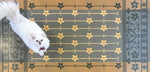 Load image into Gallery viewer, A full image of our StarFlower Floorcloth #4 with Opal providing scale.
