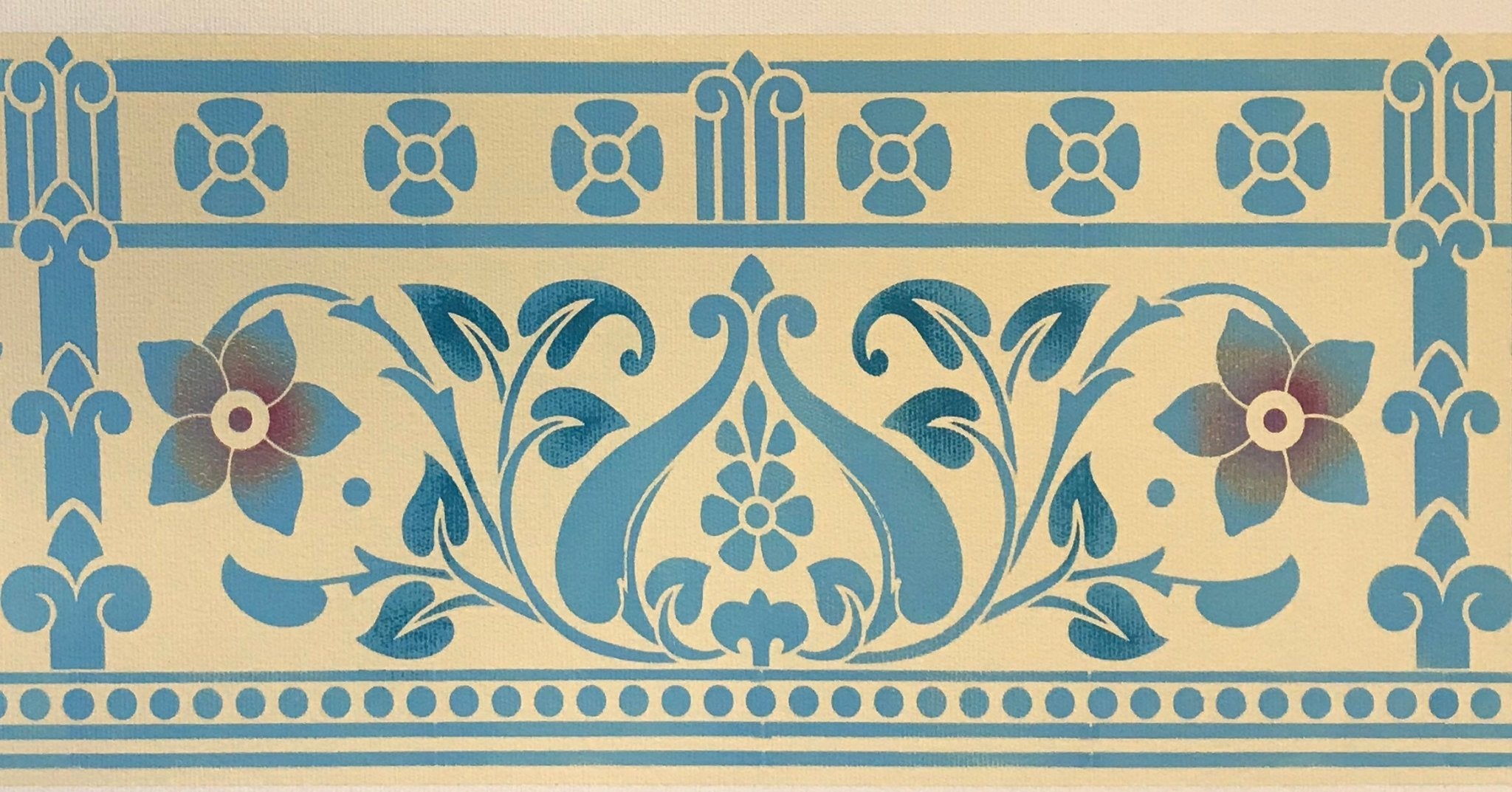 A close up of the border of this floorcloth with a pattern based on a Christopher Dresser design, c. 1875.  The leaves have been highlighted in a darker blue and the center of the flowers are highlighted in a mix of gold and red.